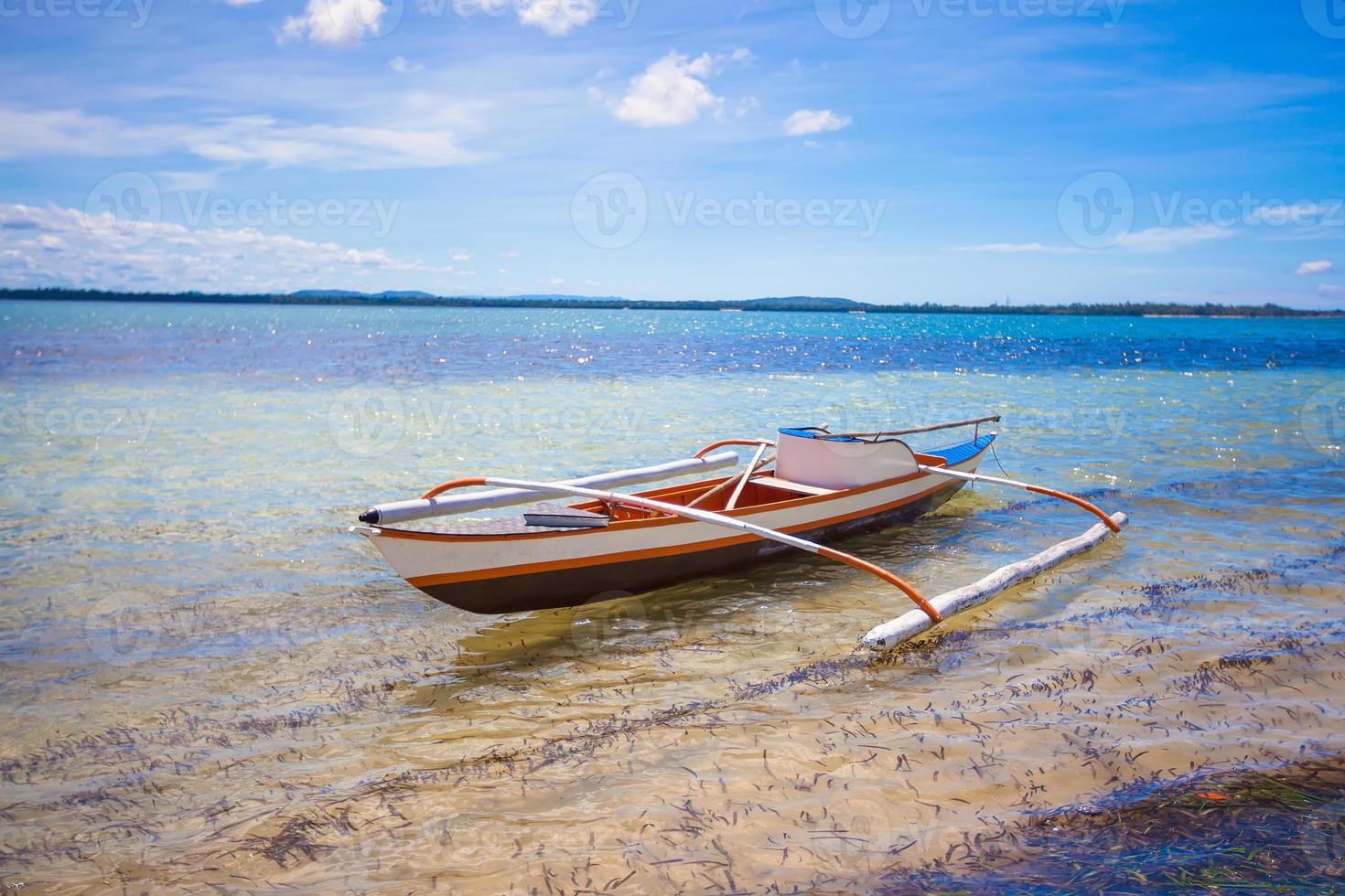 Small fishing boat in turquoise lagoon photo