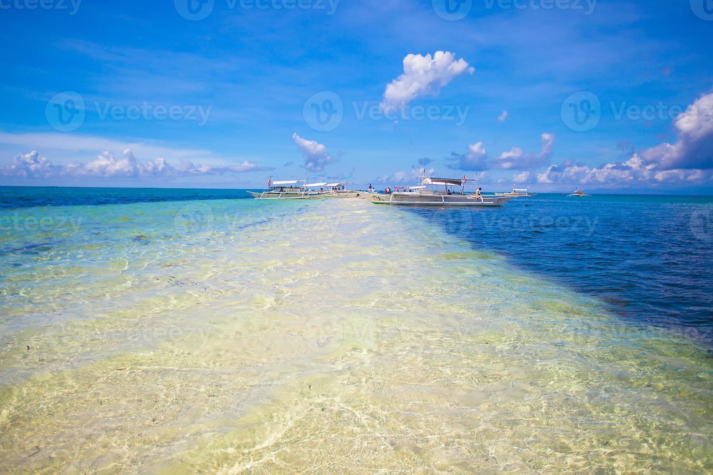 Small boats on the white tropical beach photo