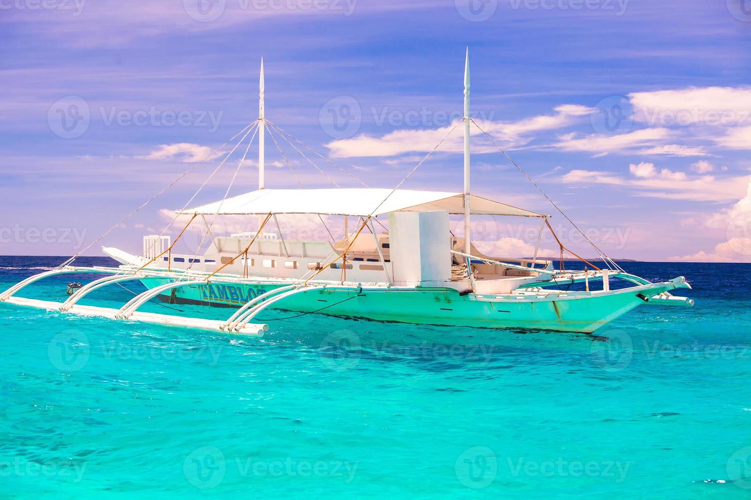 Big catamaran in turquoise open sea near Bohol island photo