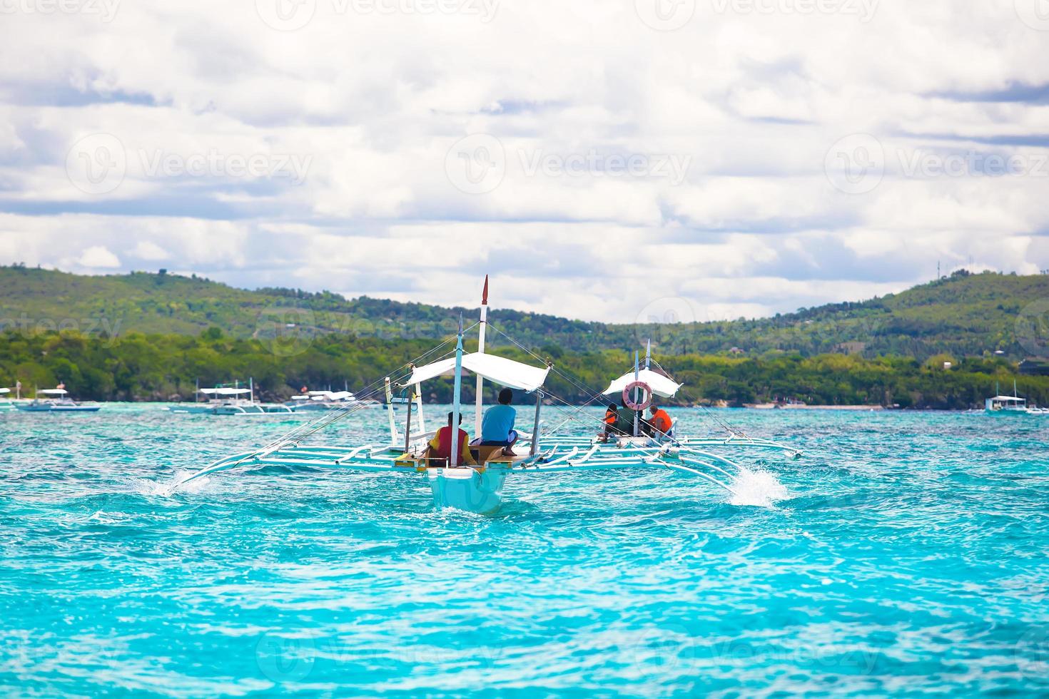 Big catamaran in turquoise open sea near Bohol island photo