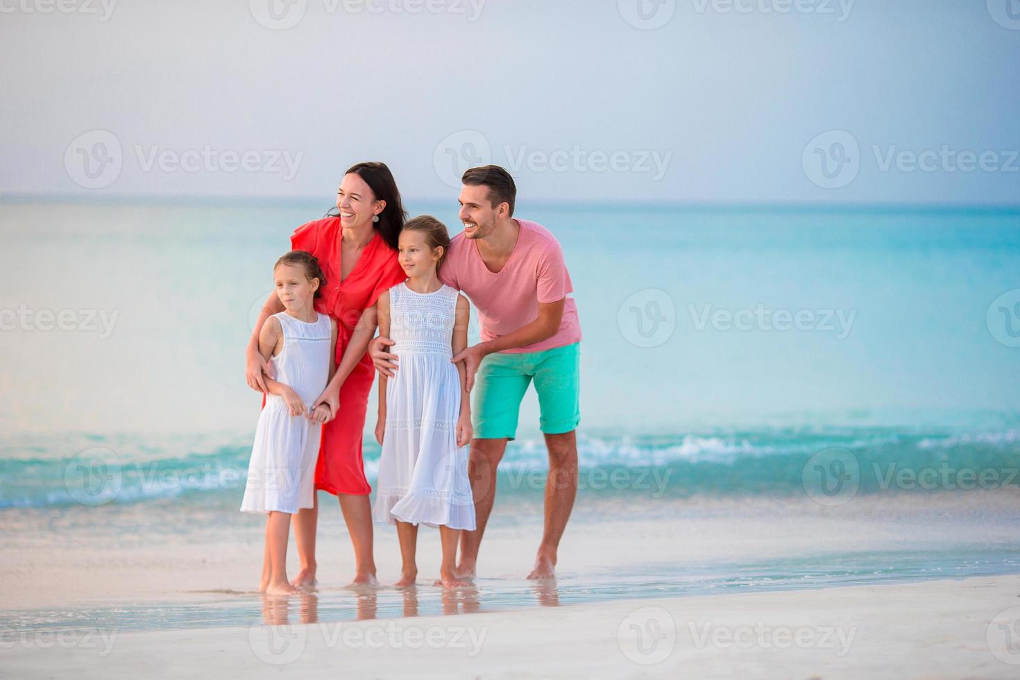 Happy beautiful family on the beach photo