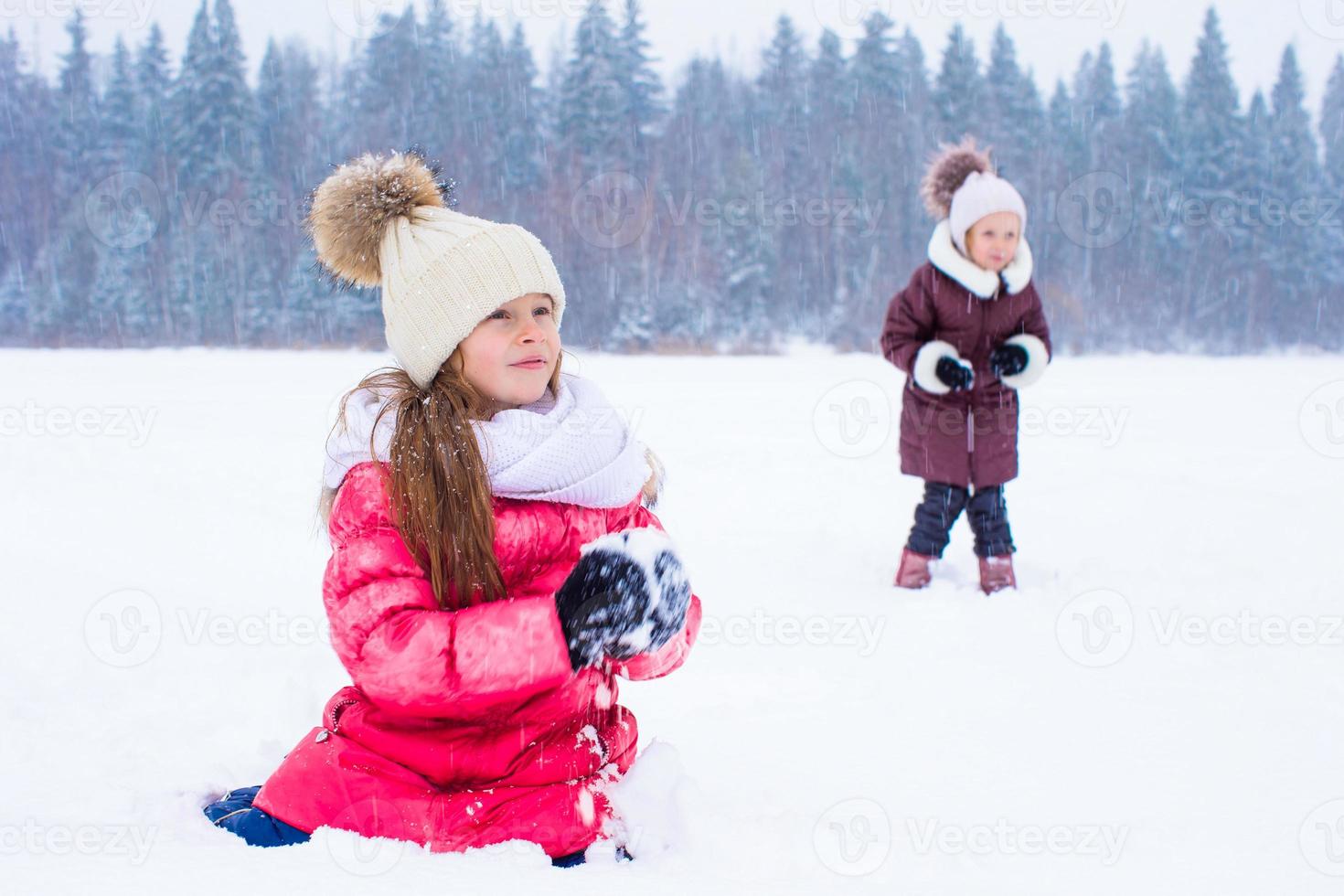 Adorable little girls outdoors on winter snow day photo