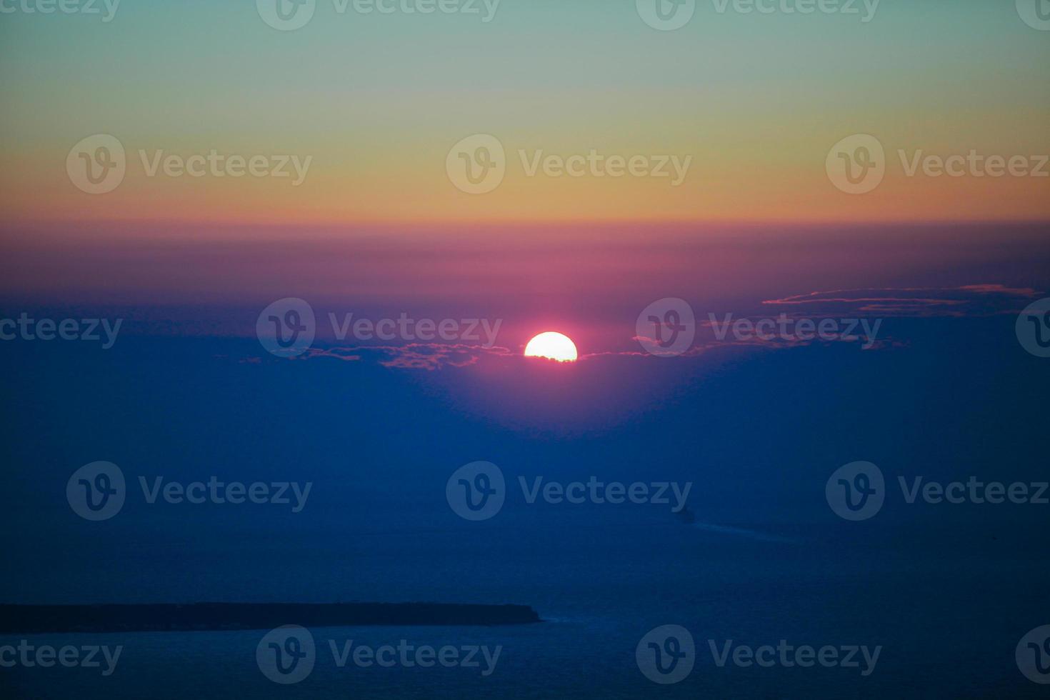 Famous sunset above Caldera view over sea in Santorini Island photo