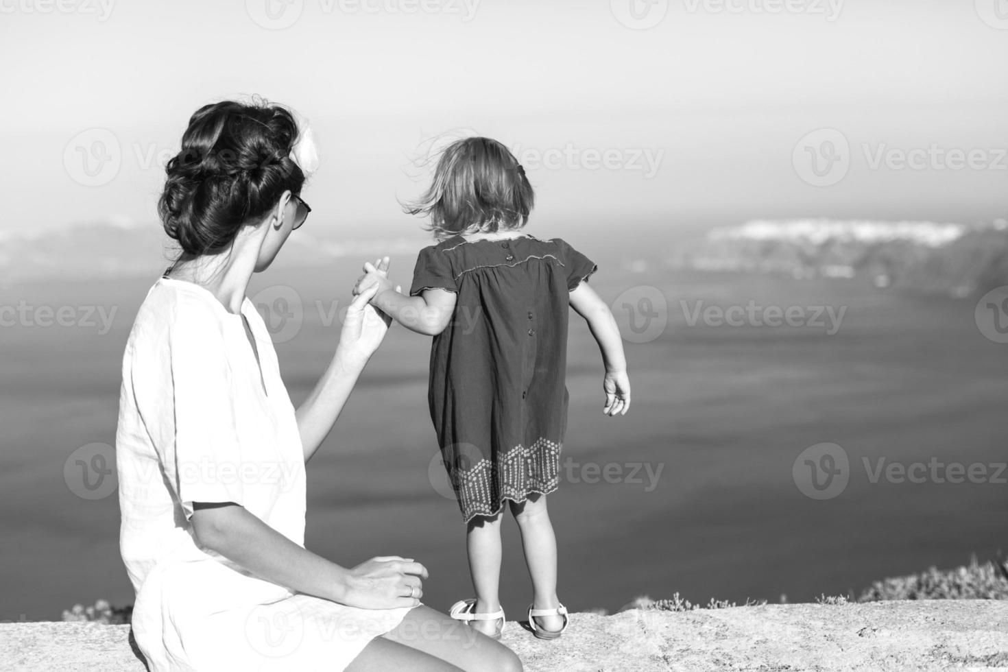 Mother and little girl in european vacation in greek town, santorini photo