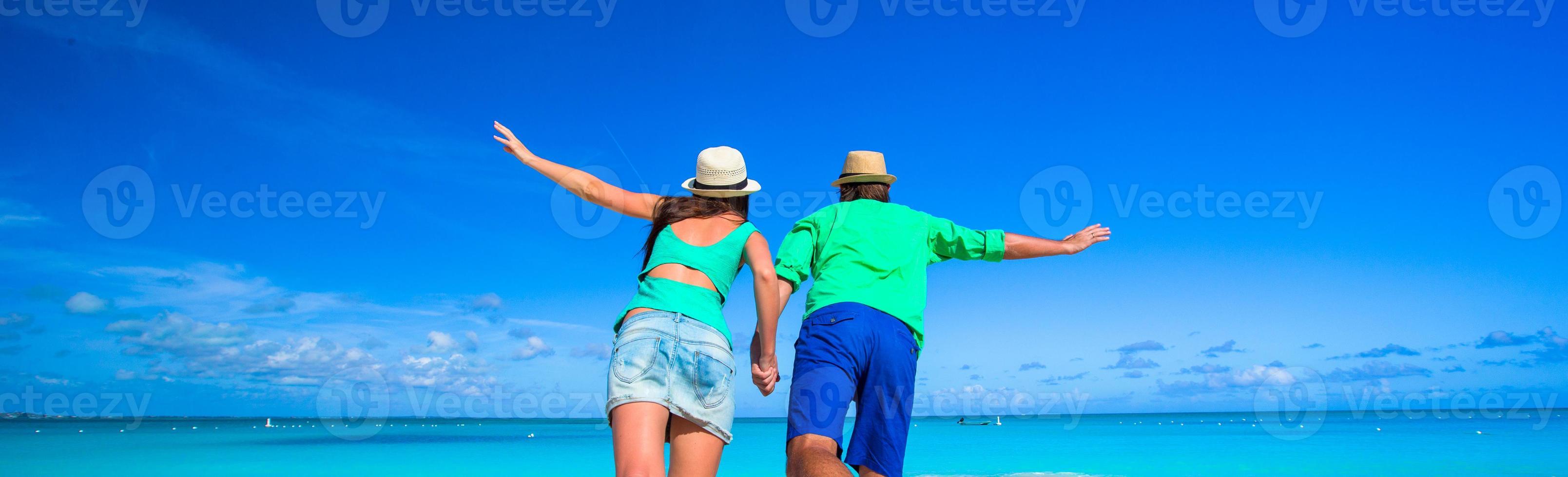Young happy couple during tropical beach vacation photo