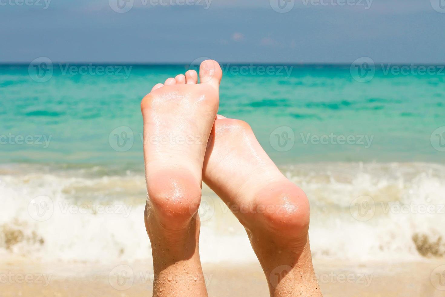 Women's beautiful legs background the turquoise water photo