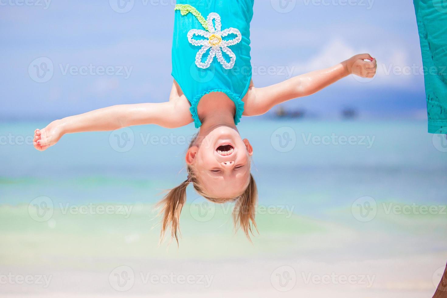 Adorable funny little girl outdoors during summer vacation have fun with her young father photo