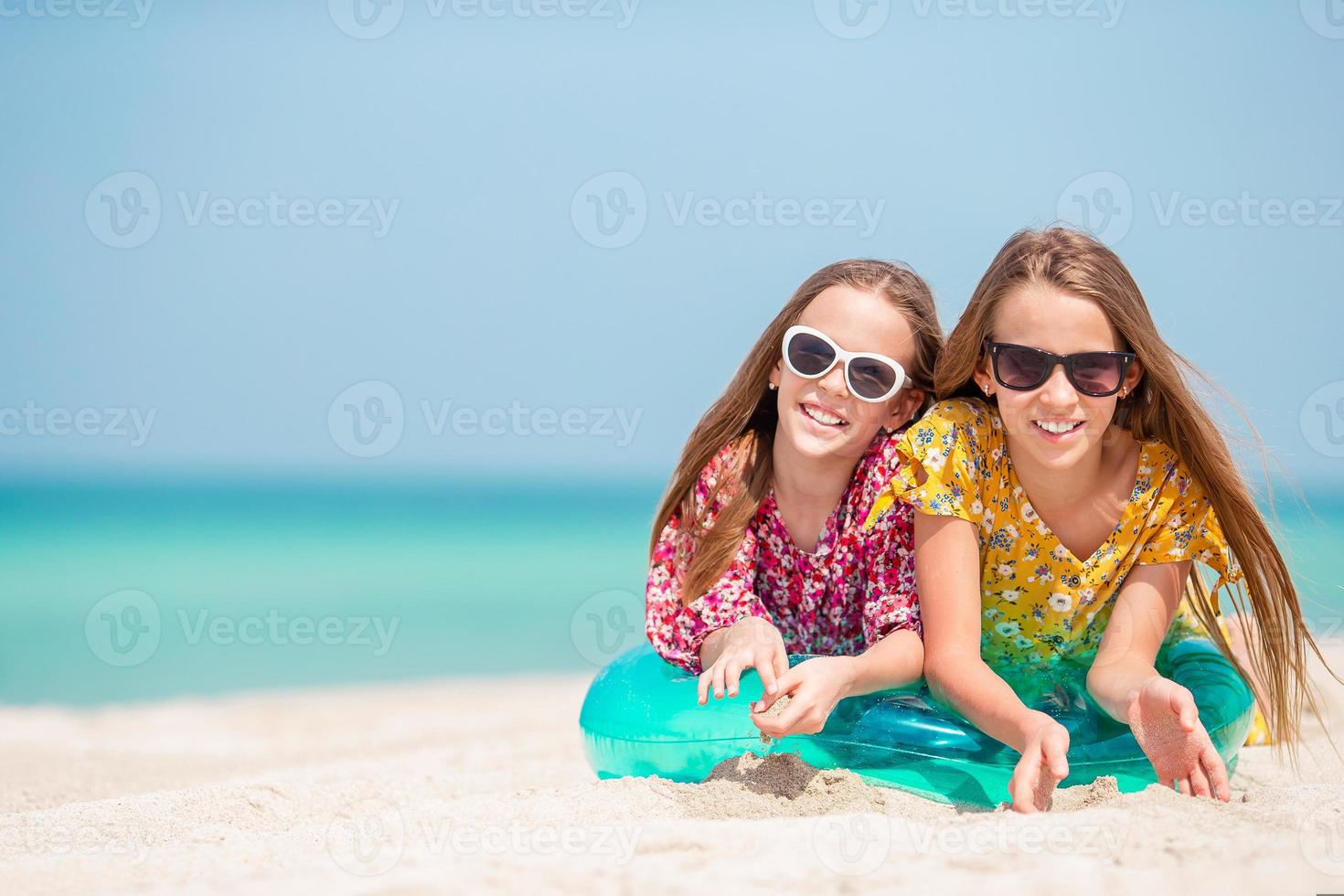 Adorable little girls during summer vacation have fun together photo