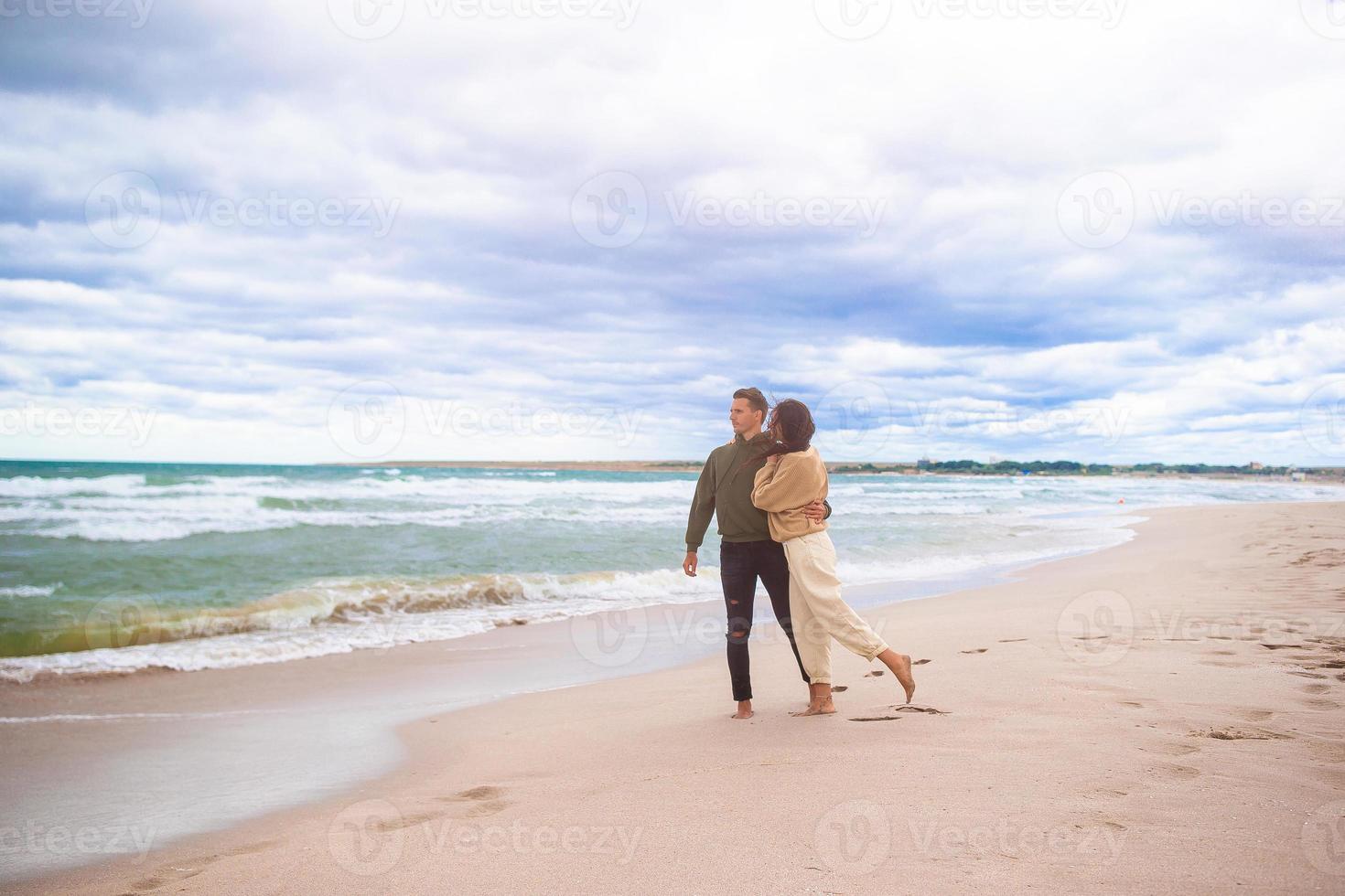 Young family on the beach in the storm photo