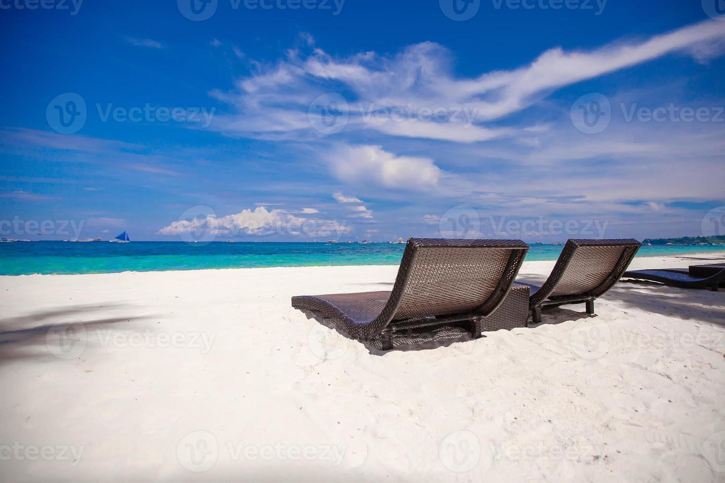 Beach wooden chairs for vacations and relax on tropical white sand plage photo