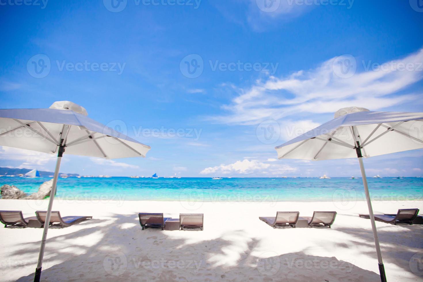 White umbrella at beach background the blue sea photo