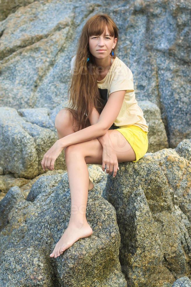 Portrait of Young beautiful woman walking at exotic resort photo