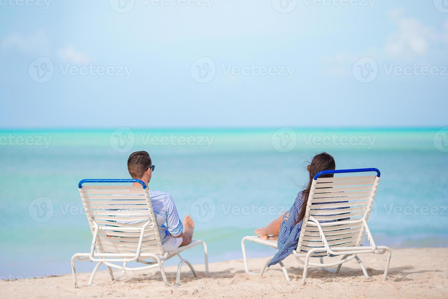 Couple relax on a tropical beach at Maldives photo