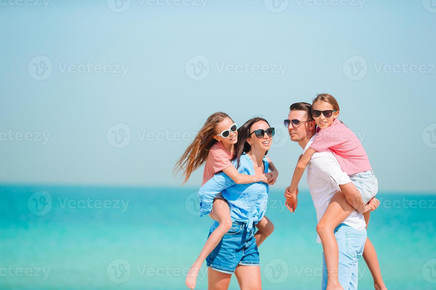Happy family on the beach during summer vacation photo