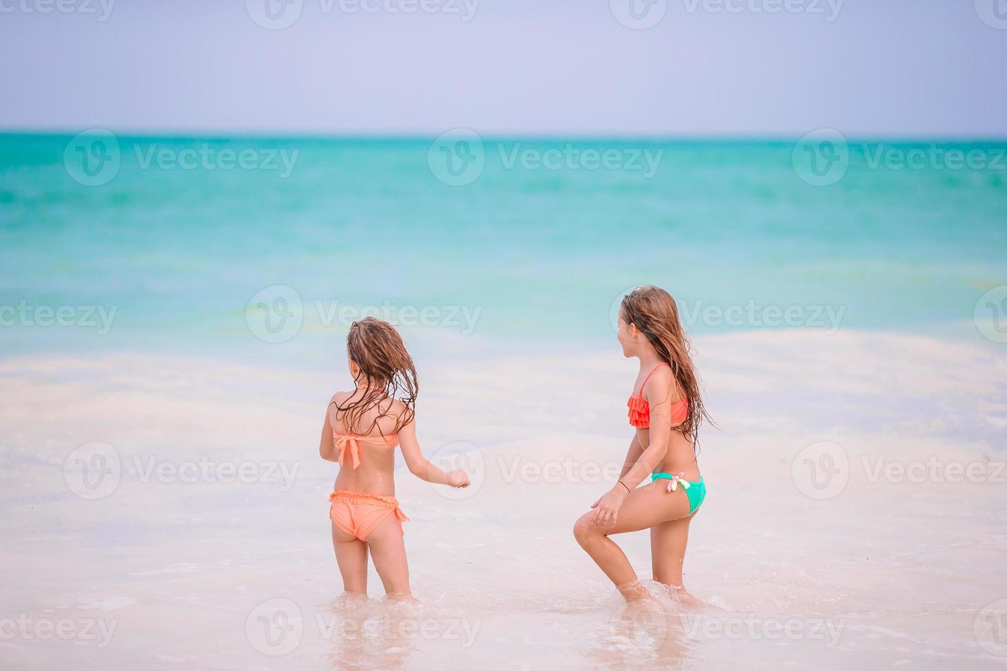 Kids have a lot of fun at tropical beach playing together photo