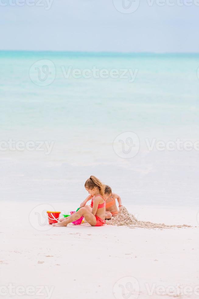 Adorable little girls during summer vacation on the beach photo