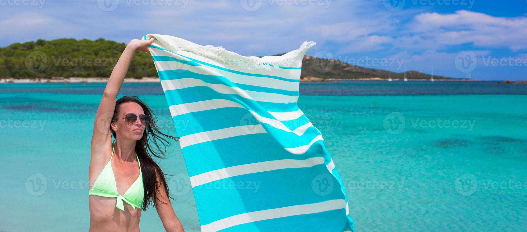 Happy woman have fun with beach towel and very happy photo