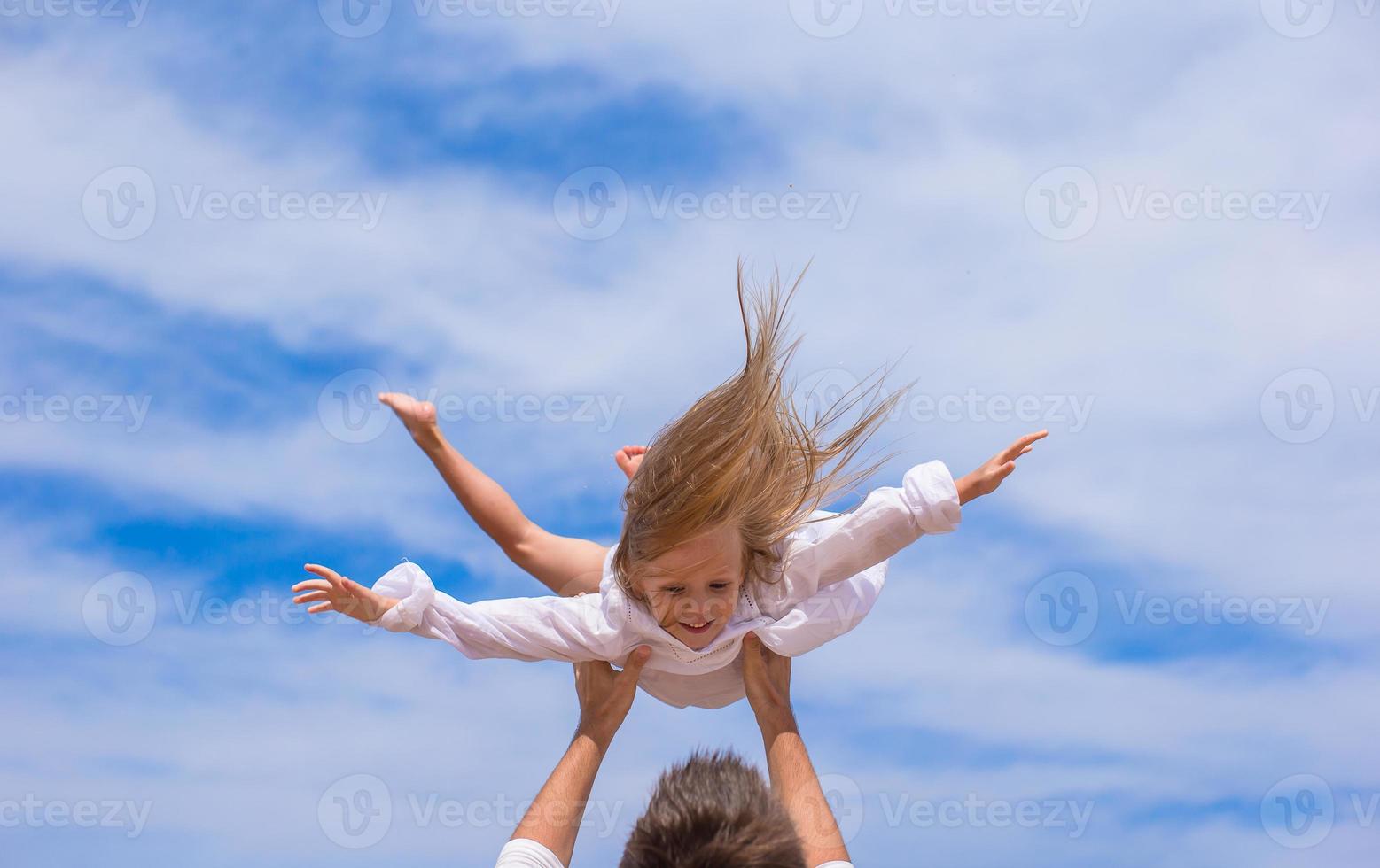 Adorable little girl and happy father have fun photo