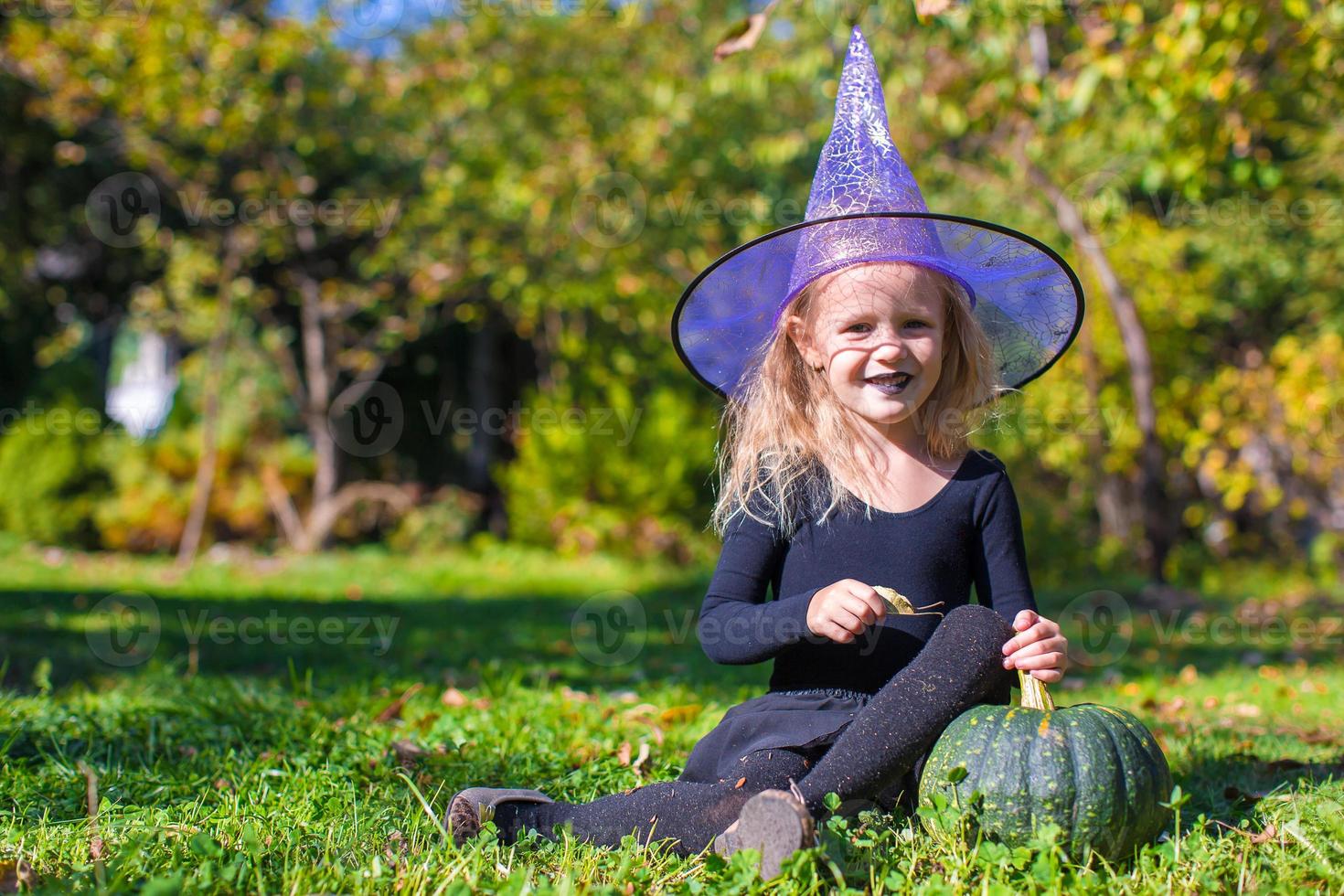 Cute little girl in Halloween which costume have fun outdoor photo