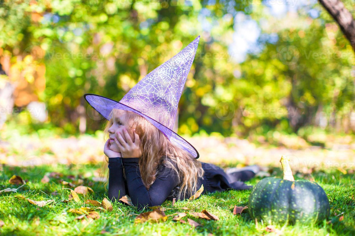 Happy little girl in halloween costume with jack pumpkin.Trick or treat photo