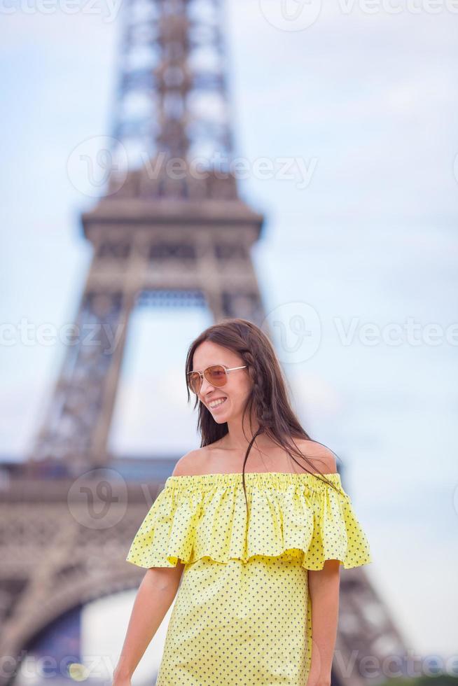 Happy woman in Paris background the Eiffel tower during summer vacation photo