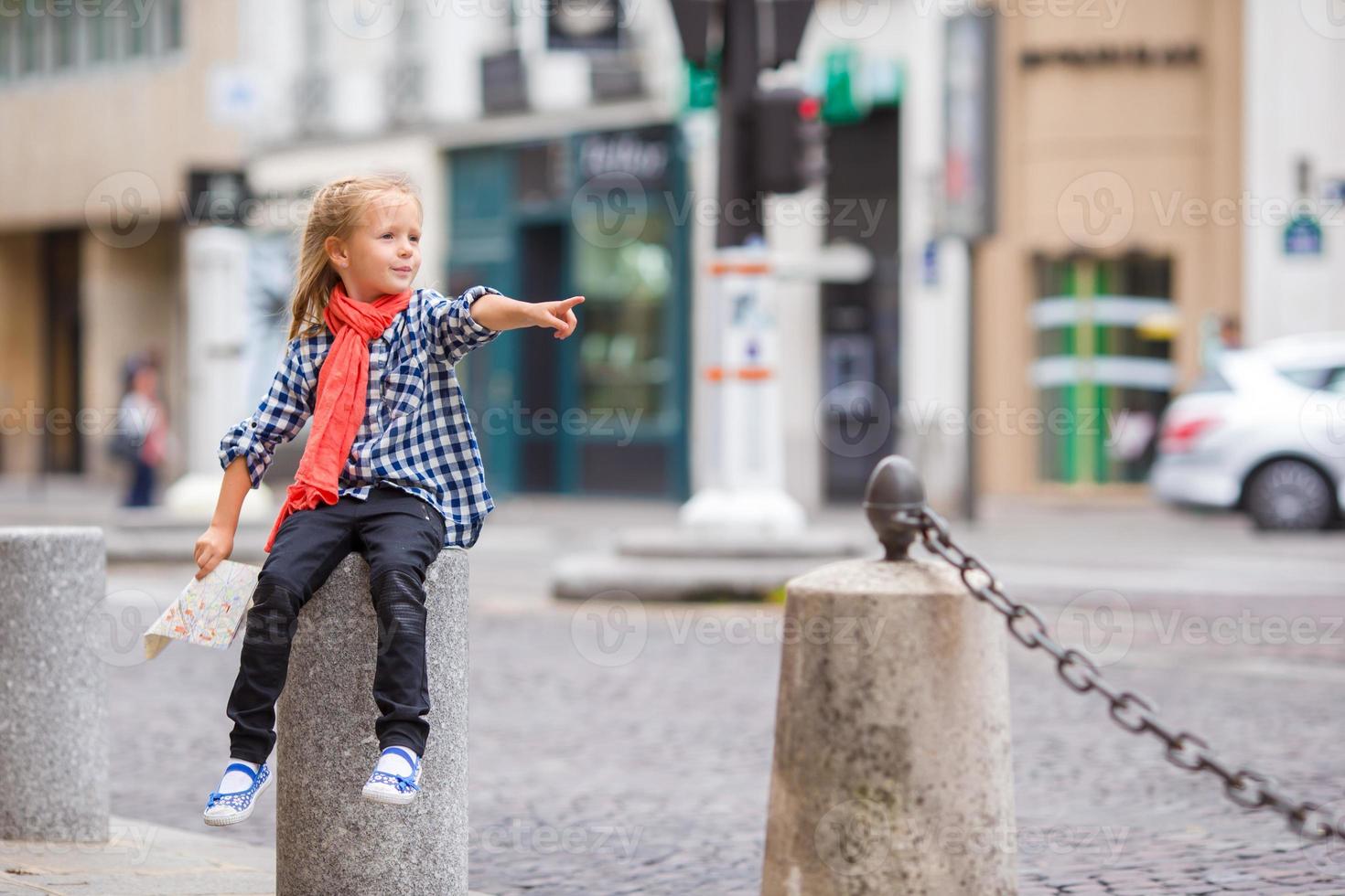 Adorable little girl at european city outdoors photo