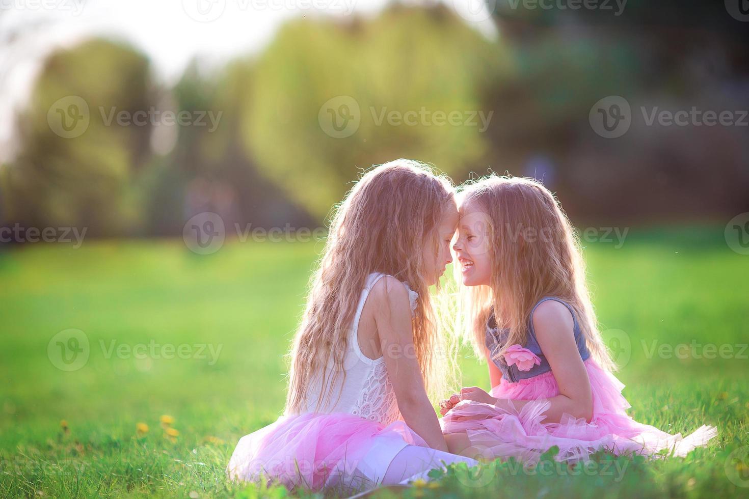 Adorable little girls on spring day outdoors photo