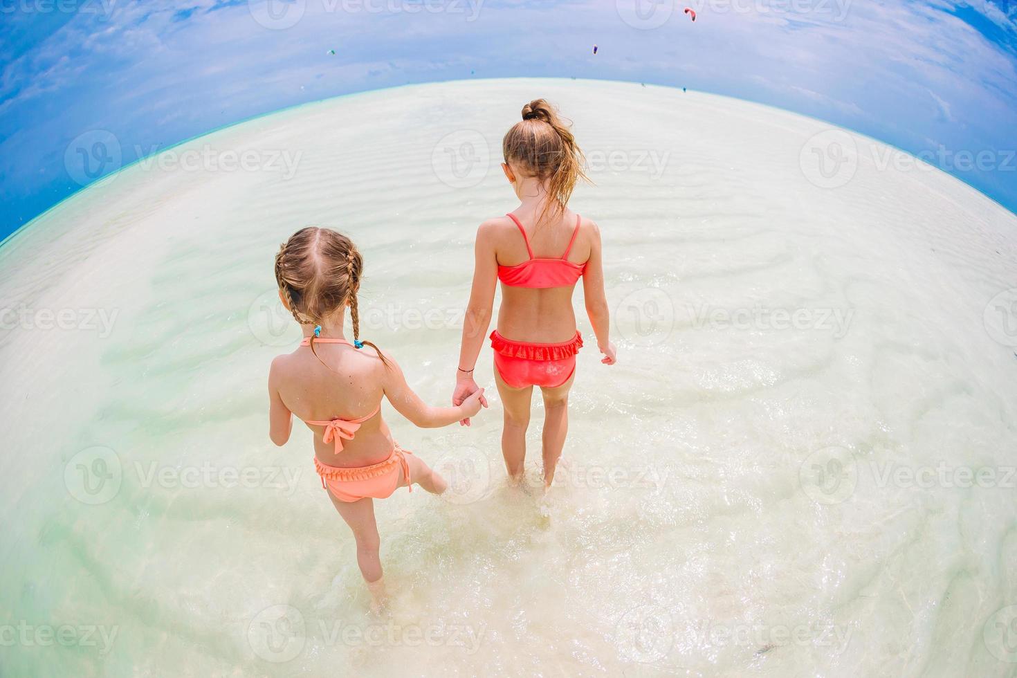 Kids have a lot of fun at tropical beach playing together photo