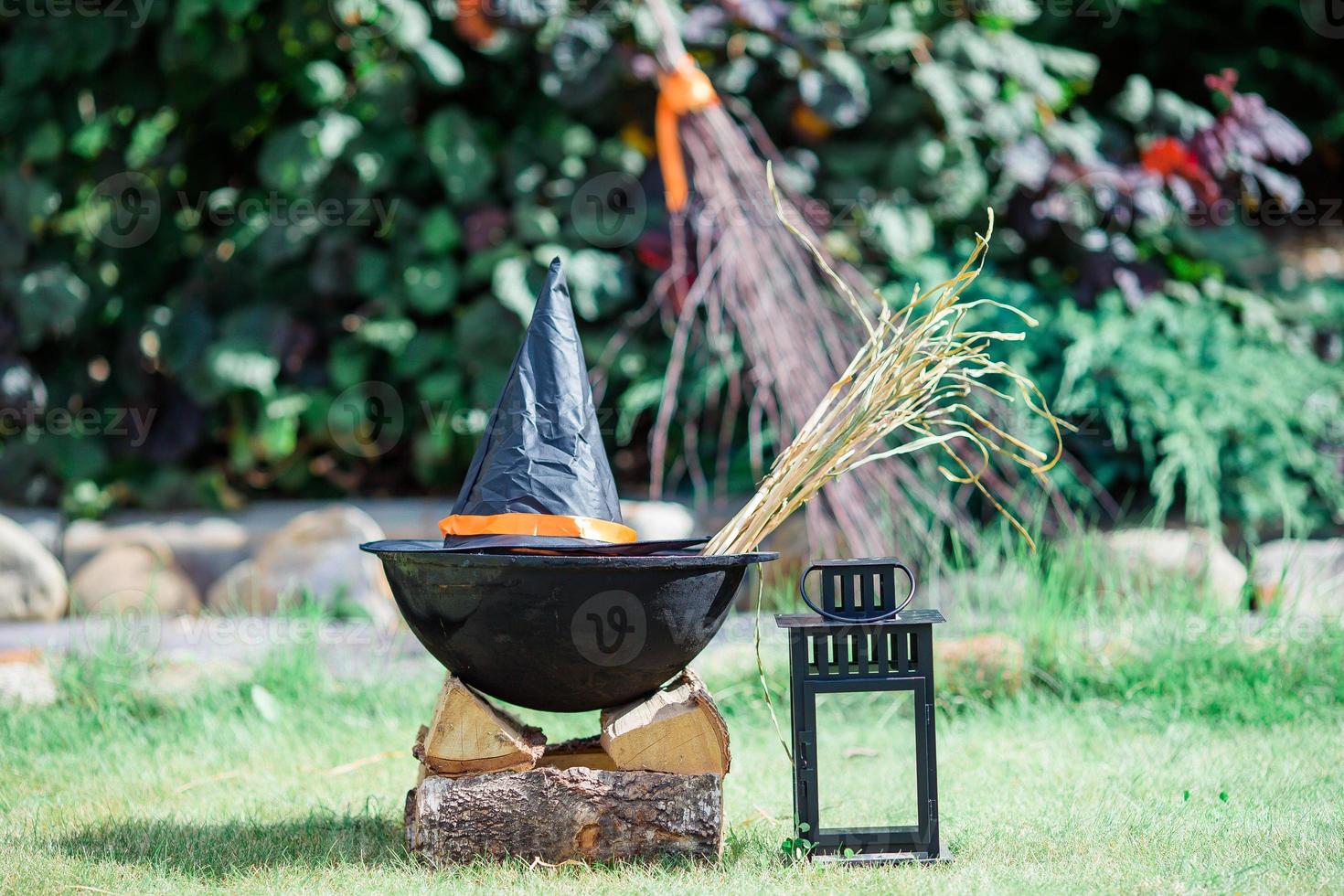 View of Halloween Pumpkins, witch's hat and rake outdoor photo