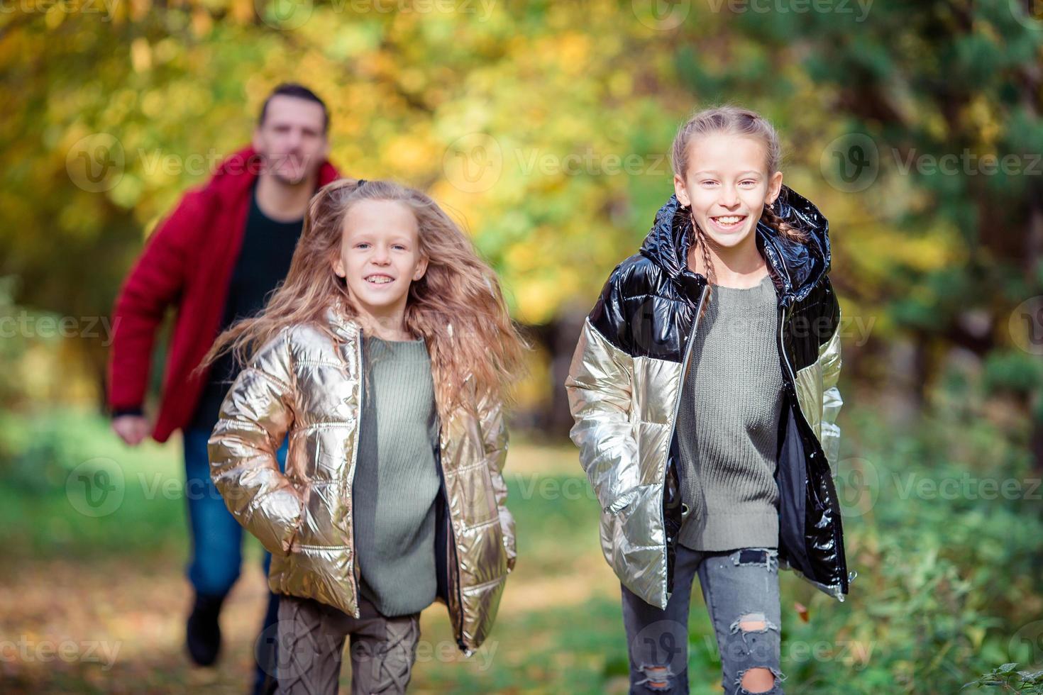 Family of dad and kids on beautiful autumn day photo