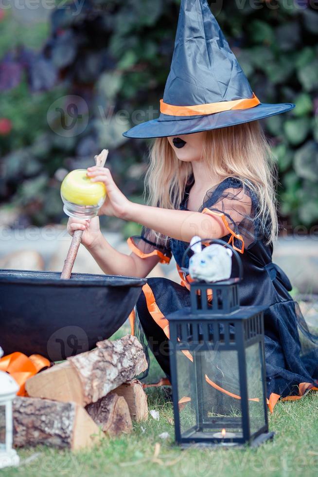 Happy girl in halloween costume with jack pumpkin.Trick or treat photo