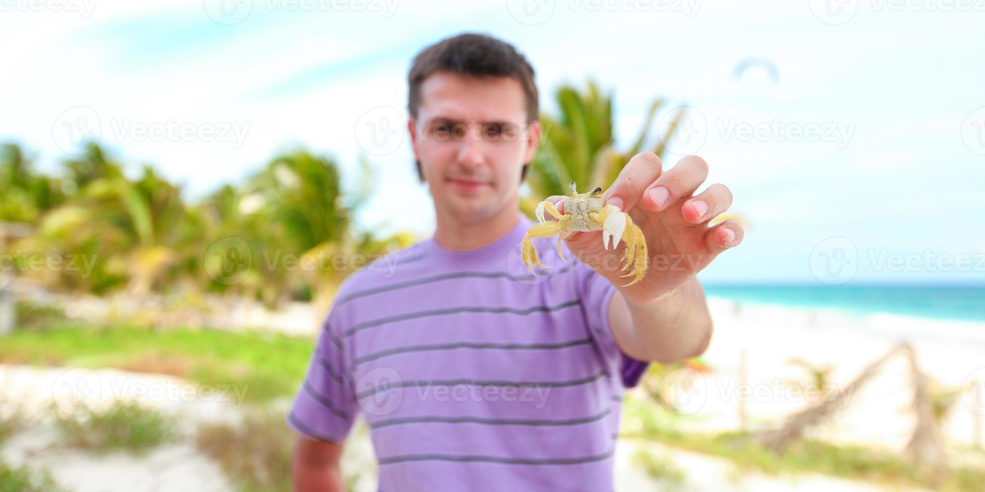 Close up of man's hand holding crab photo