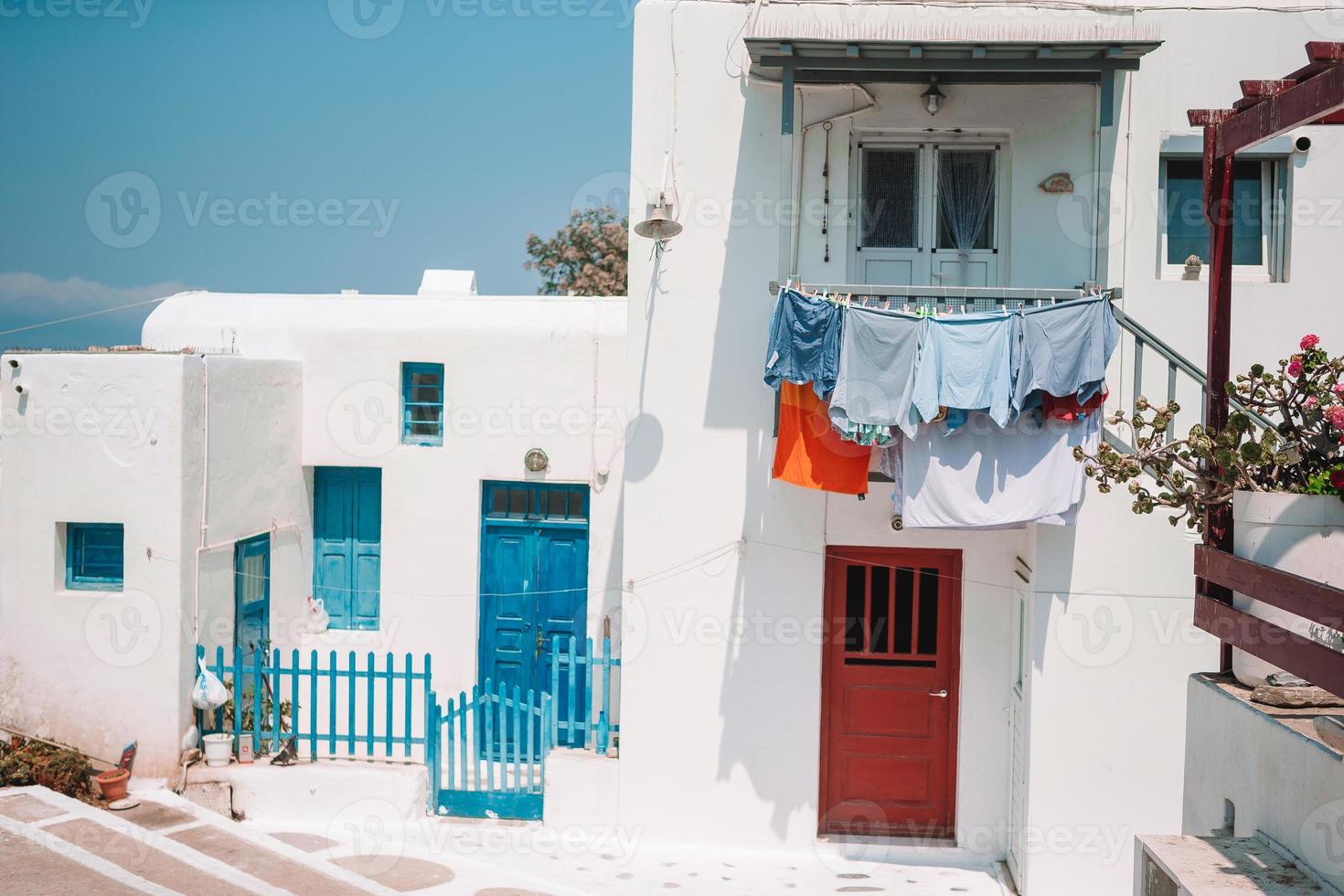 The narrow streets of the island with blue balconies, stairs and flowers. photo