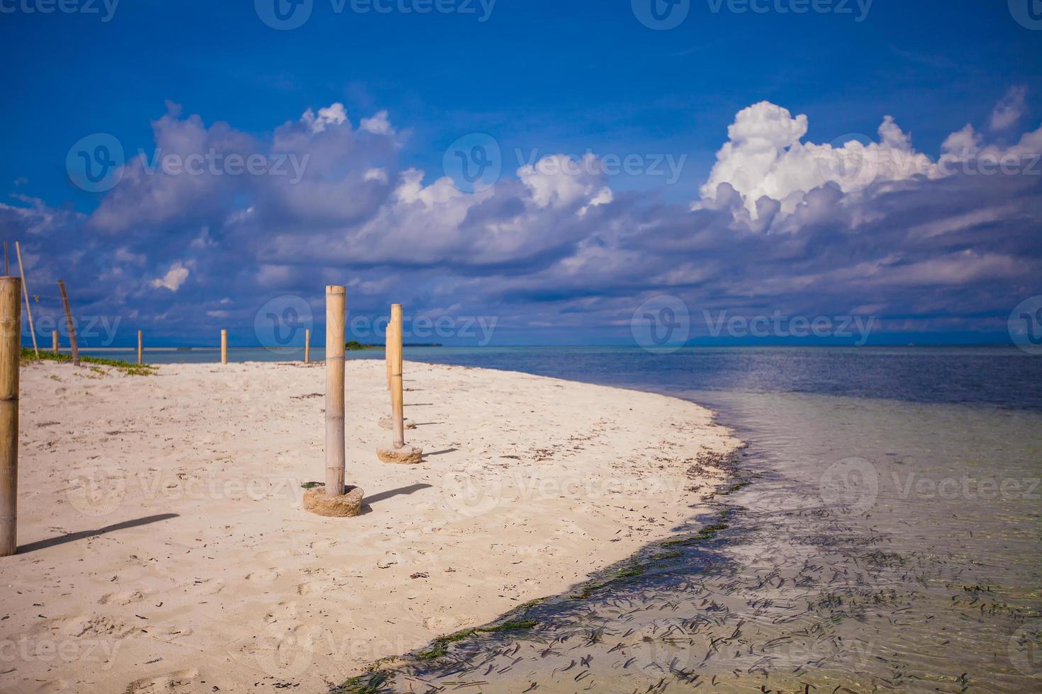 playa blanca perfecta con agua turquesa y una pequeña valla en una isla desierta foto