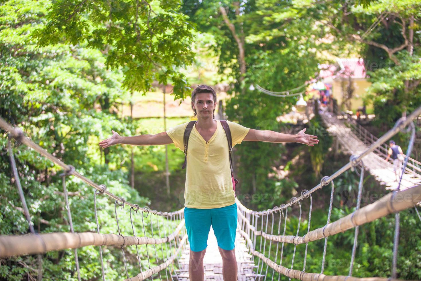 Young guy on suspension bridge over the River Loboc, Philippines photo