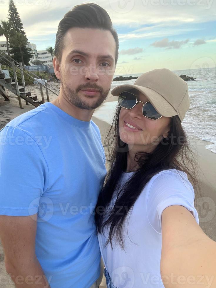 Young couple on white beach during summer vacation photo