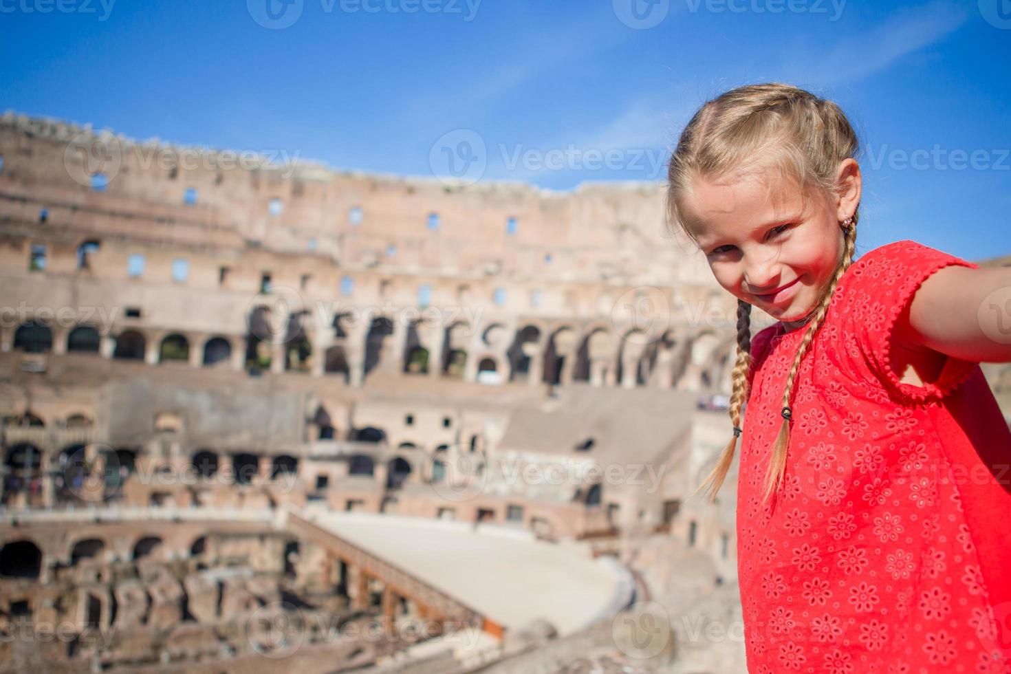 Little girl making selfie in Coliseum, Rome, Italy. Kid portrait at famous places in Europe photo