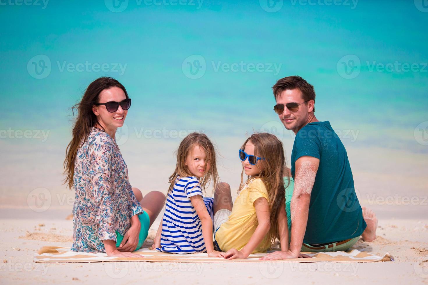 Happy beautiful family with kids together on tropical beach during summer vacation photo