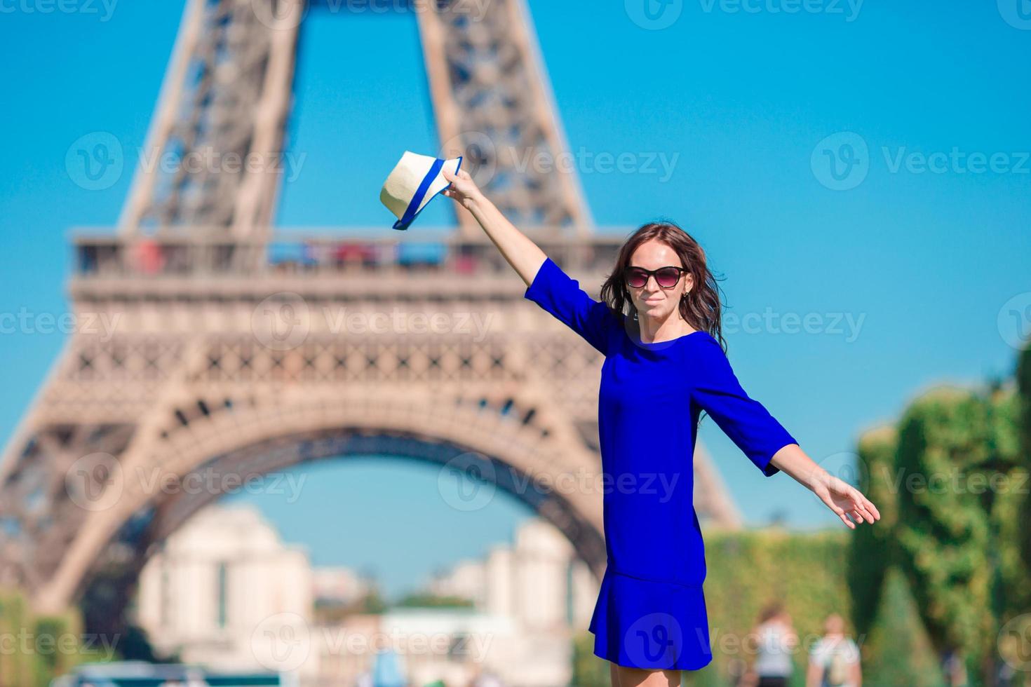 Beautiful woman in Paris background the Eiffel tower during summer vacation photo