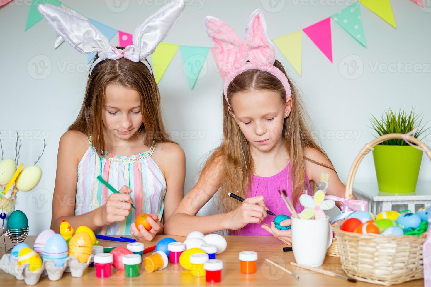 Happy easter. Beautiful little kids wearing bunny ears on Easter day. photo