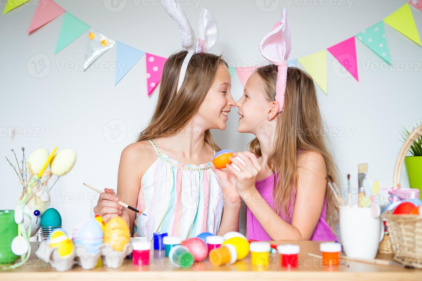 Happy easter. Beautiful little kids wearing bunny ears on Easter day. photo