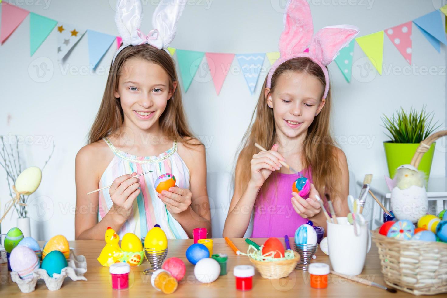 Happy easter. Beautiful little kids wearing bunny ears on Easter day. photo