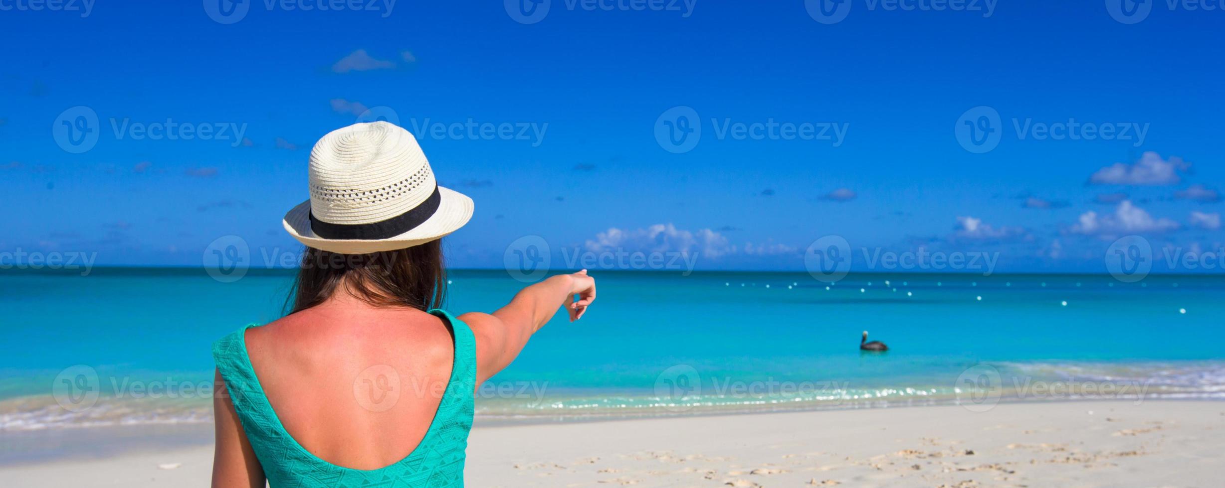 Young happy woman on beach during her summer vacation photo