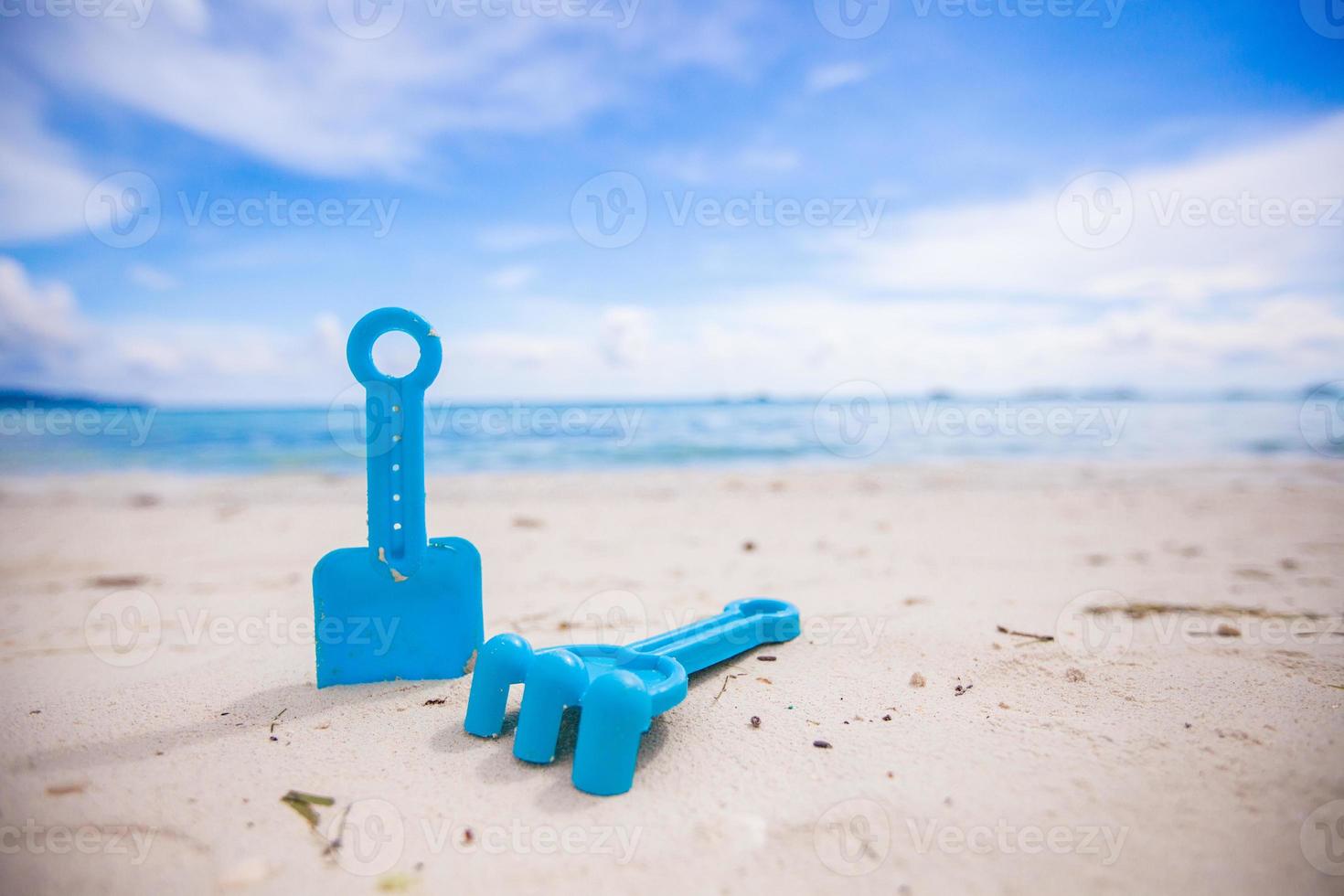 close-up of children's toys on a white beach photo