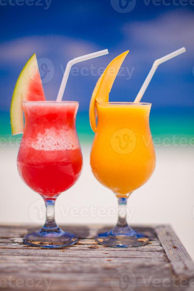 Close up fresh watermelon and mango cocktails on the background of stunning turquoise sea photo