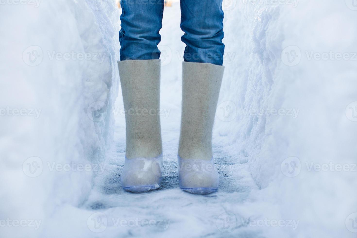 Close-up of warm boots for men's feet on the white snow photo