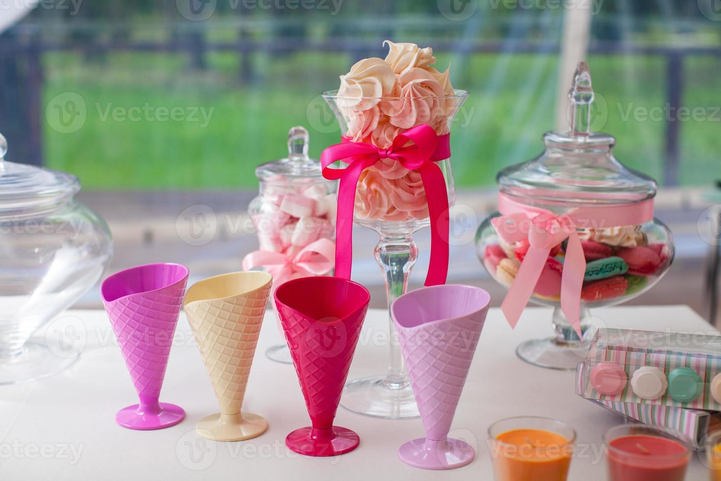 Beautifully decorated wedding table with a sweet macaroon and cakes photo