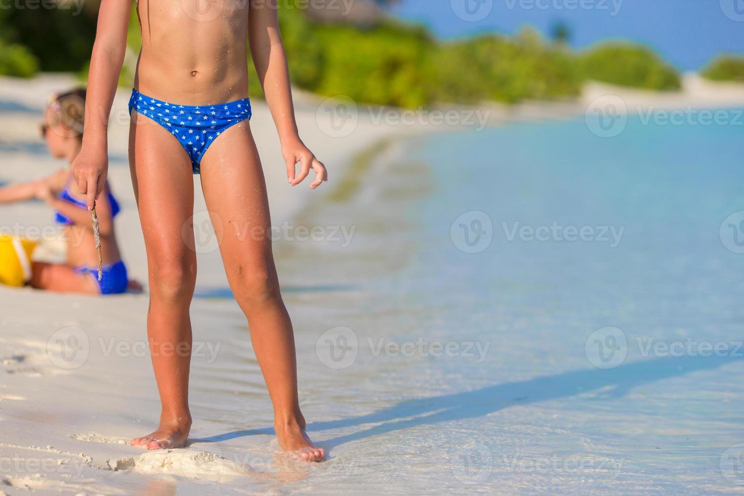 Adorable little girl at beach during summer vacation photo
