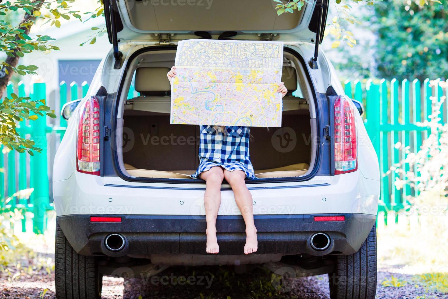 Little kid sitting in car while traveling photo