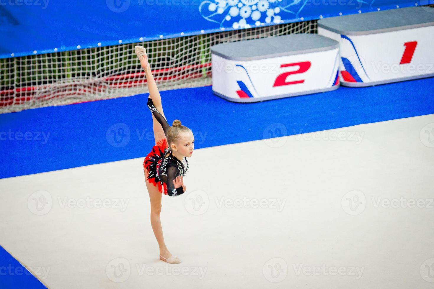 Adorable gymnast participates in competitions in rhythmic gymnastics photo